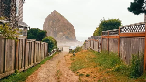 Haystack Rock Pathway to the beach with towering rock in the distance. A narrow Stock Footage 289309941