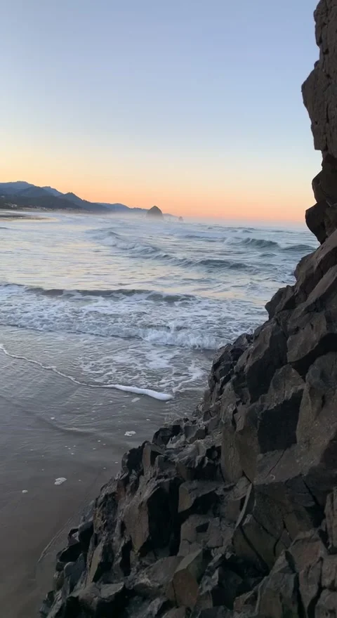 Haystack Rock from a remote beach shot from a wanderers point of view Stock Footage 241560405