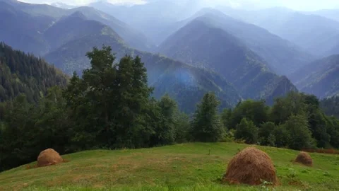 Haystacks against the background of mountains. Stock Footage 279237108