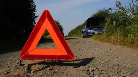 Hazard warning triangle by broken down car on country road uk Stock Footage 67530483