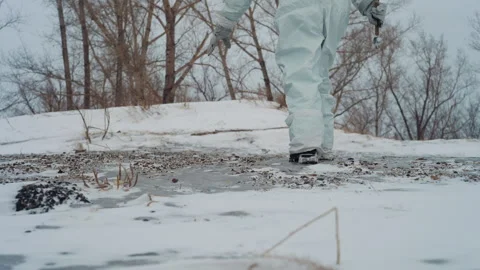 Hazardous icy terrain. Technician examines fragile ice surface. Fieldworker Stock Footage 346472086