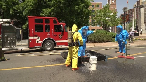 Hazardous material special unit members during clean up process Stock Footage 127936359