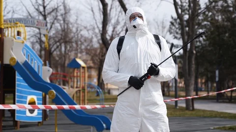 Hazardous materials removal worker in protective hazmat suit and face mask with Stock Footage 129286589