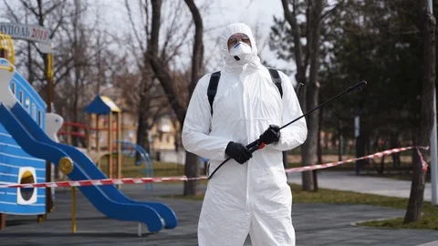 Hazardous materials removal worker wears protective hazmat suit and face mask Stock Footage 127370417