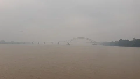 Haze and thick smoke from forest fires blanketing a river in West Kalimantan Video stock 345693544