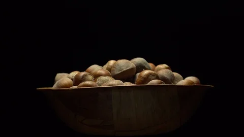 Hazel nuts in nutshell. Rotation. Closeup. Selective focus. Black background. Stock Footage 101553264