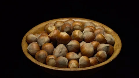 Hazel nuts in nutshell. Rotation. Closeup. Selective focus. Black background. Stock Footage 101553333