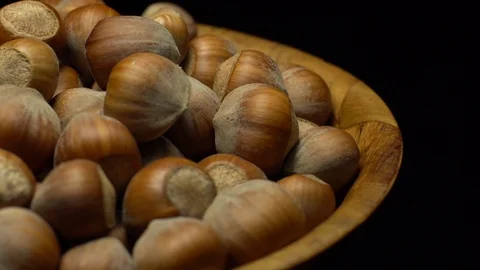 Hazel nuts in nutshell. Rotation. Closeup. Selective focus. Black background. Stock Footage 101553343