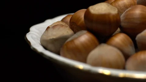 Hazel nuts in nutshell. Rotation. Closeup. Selective focus. Black background. Stock Footage 101554629