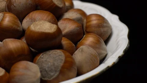 Hazel nuts in nutshell. Rotation. Closeup. Selective focus. Black background. Stock Footage 101554637