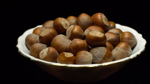 Hazel nuts in nutshell. Rotation. Closeup. Selective focus. Black background. Stock Footage 101554693