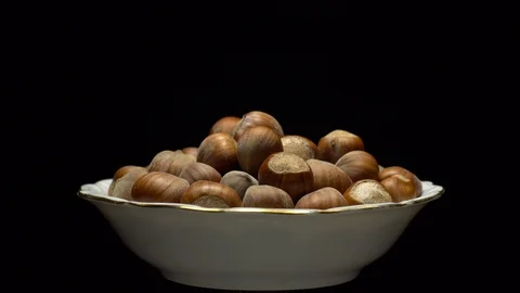 Hazel nuts in nutshell. Rotation. Closeup. Selective focus. Black background. Stock Footage 101554789