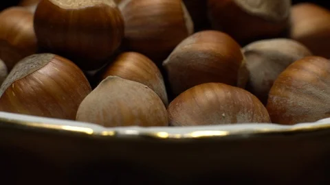 Hazel nuts in nutshell. Rotation. Closeup. Selective focus. Black background. Stock Footage 101555063