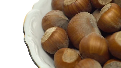 Hazel nuts in nutshell. Rotation. Closeup. Selective focus. Isolated on white. Stock Footage 101556075