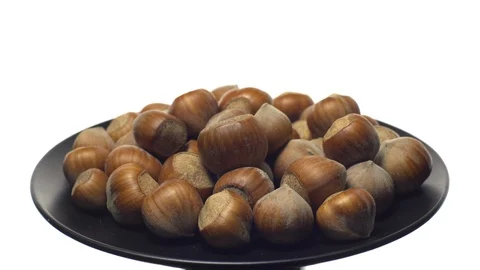 Hazel nuts in nutshell. Rotation. Closeup. Selective focus. Isolated on white. Stock Footage 101556150