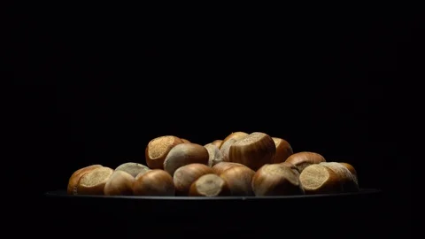 Hazel nuts in nutshell. Rotation. Closeup. Selective focus. Black background. Stock Footage 101556573