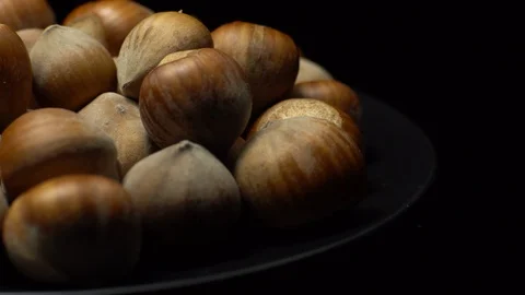 Hazel nuts in nutshell. Rotation. Closeup. Selective focus. Black background. Stock Footage 101556603
