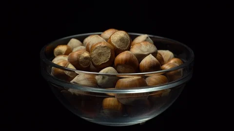 Hazel nuts in nutshell. Rotation. Closeup. Selective focus. Black background. Stock Footage 101556746