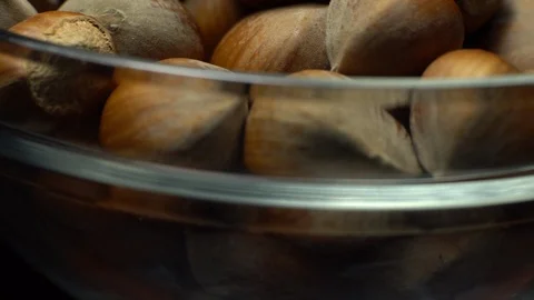 Hazel nuts in nutshell. Rotation. Closeup. Selective focus. Black background. Stock Footage 101587352