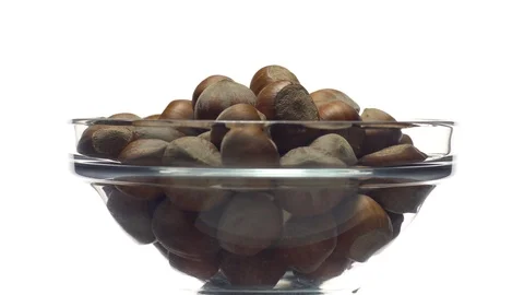 Hazel nuts in nutshell. Rotation. Closeup. Selective focus. Isolated on white. Stock Footage 101587776