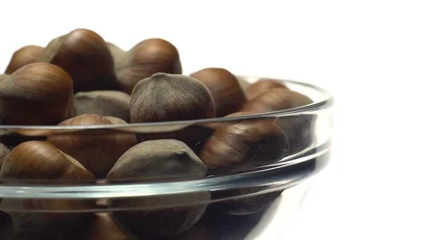 Hazel nuts in nutshell. Rotation. Closeup. Selective focus. Isolated on white. Stock Footage 101587961