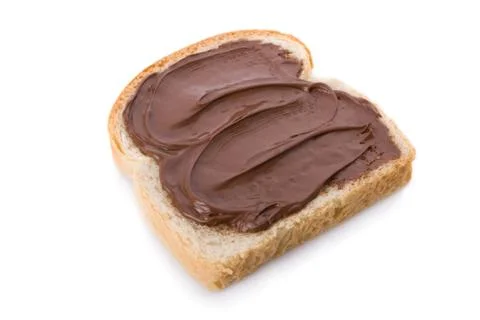 Hazelnut and chocolate spread over a slice of bread. Stock Photos