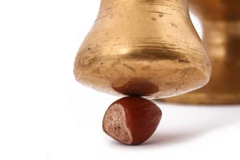 The hazelnut and in the leaf old metal nutcracker on white background Stock Photos