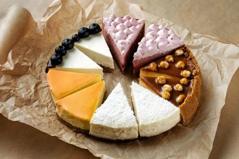 Hazelnut-chocolate cake, cut into triangular pieces on kraft paper. 스톡 사진