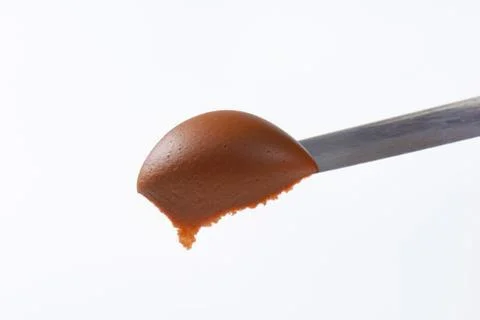 Hazelnut chocolate spread on knife Stock Photos