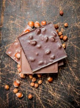 Hazelnut chocolate on wooden background. Stock Photos