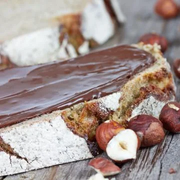 Hazelnut cream on bread Stock Photos