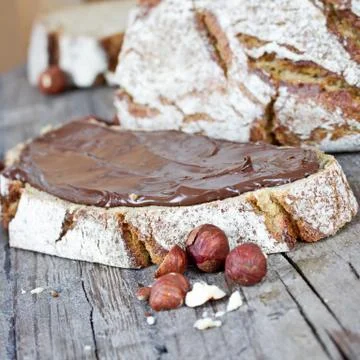 Hazelnut cream on bread Stock Photos