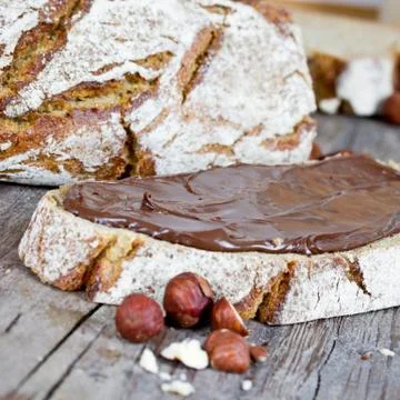 Hazelnut cream on bread Stock Photos