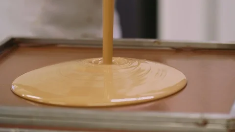 Hazelnut cream poured into a baking tin Stock Footage 98859859