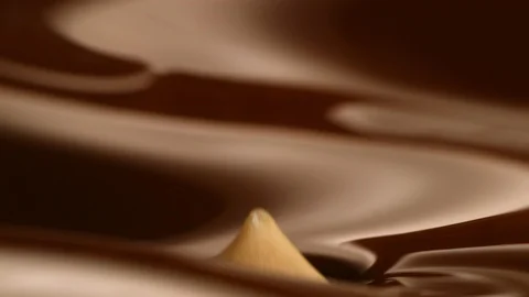 Hazelnut fall into chocolate bath12 Stock-Footage 94565132
