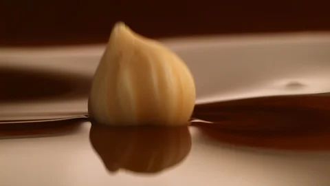 Hazelnut fall into chocolate bath2 Stock-Footage 94559966