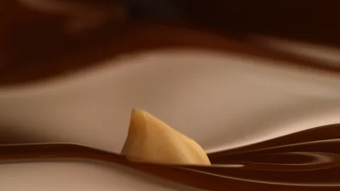 Hazelnut fall into chocolate bath4 Stock-Footage 94562820