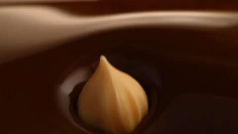 Hazelnut fall into chocolate bath6 Stock-Footage 94562372