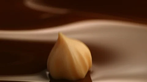 Hazelnut fall into chocolate bath8 Stock-Footage 94564392