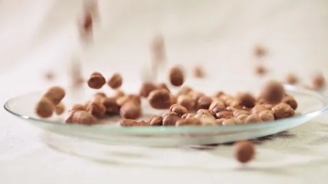 Hazelnut falling down into glass bowl Stock-Footage 72120854