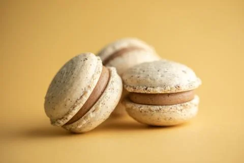Hazelnut macarons close-up on a yellow background Stock Photos