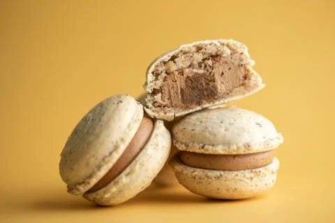 Hazelnut macarons close-up on a yellow background Stock Photos
