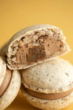 Hazelnut macarons close-up on a yellow background Stock Photos