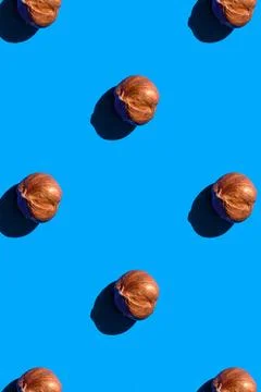 Hazelnut pattern on blue background, colorful flat lay food texture top view 스톡 사진