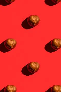 Hazelnut pattern on red background, colorful flat lay food texture top view 스톡 사진