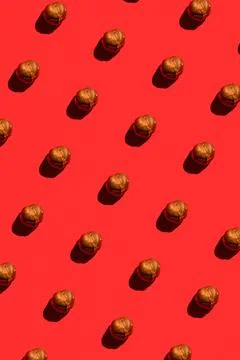 Hazelnut pattern on red background, colorful flat lay food texture top view 스톡 사진