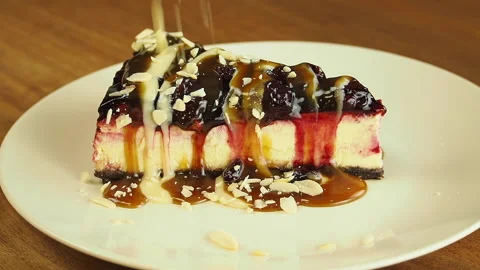 Hazelnut pouring over slice of classical cheesecake decorated with strawberries. Stock Footage 141898569
