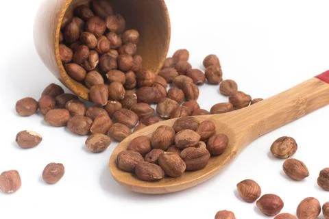 Hazelnut into a spoon Stock Photos