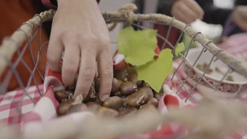 Hazelnut wicker basket woman's hand picks up nut Stock Footage 221468015