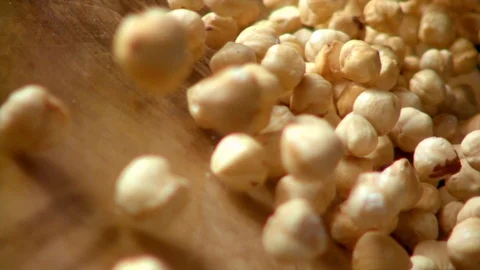 Hazelnut on wooden surface move in to camera in slow motion. Stock Footage 129003937